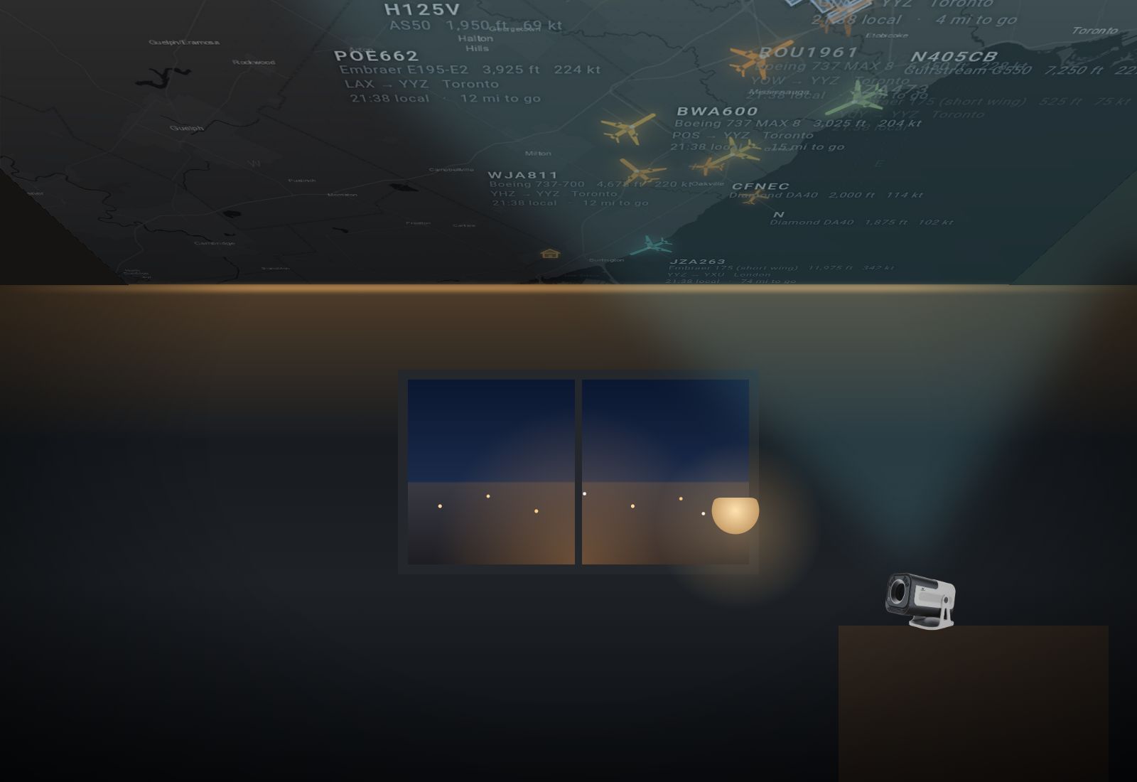A dark room at night: the projector on a shelf lights up the ceiling with a live map of aircraft, callsigns and routes.